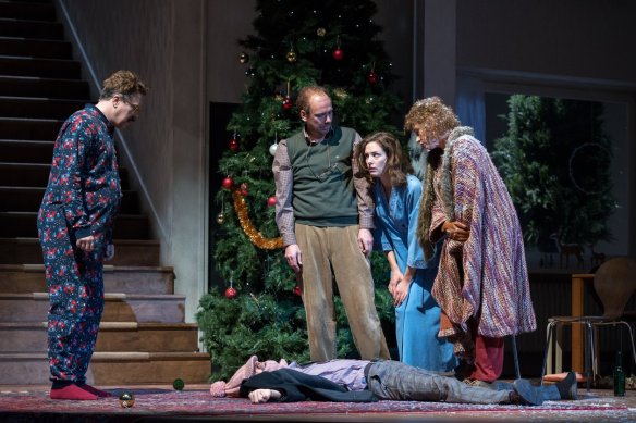 Neville (Nicholas Ofczarek), Belinda (Katharina Lorenz) and two of their guests standing around a third who lies on the floor as if dead.
