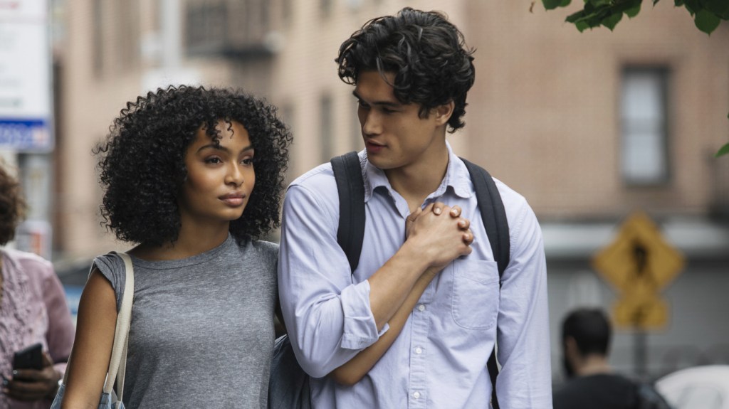 Natasha (Yara Shahidi) and Daniel (Charles Melton) walking down the street with their hands clasped.