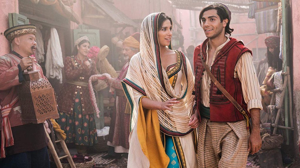 Princess Jasmine (Naomi Scott) and Aladdin (Mena Massoud) at the market.