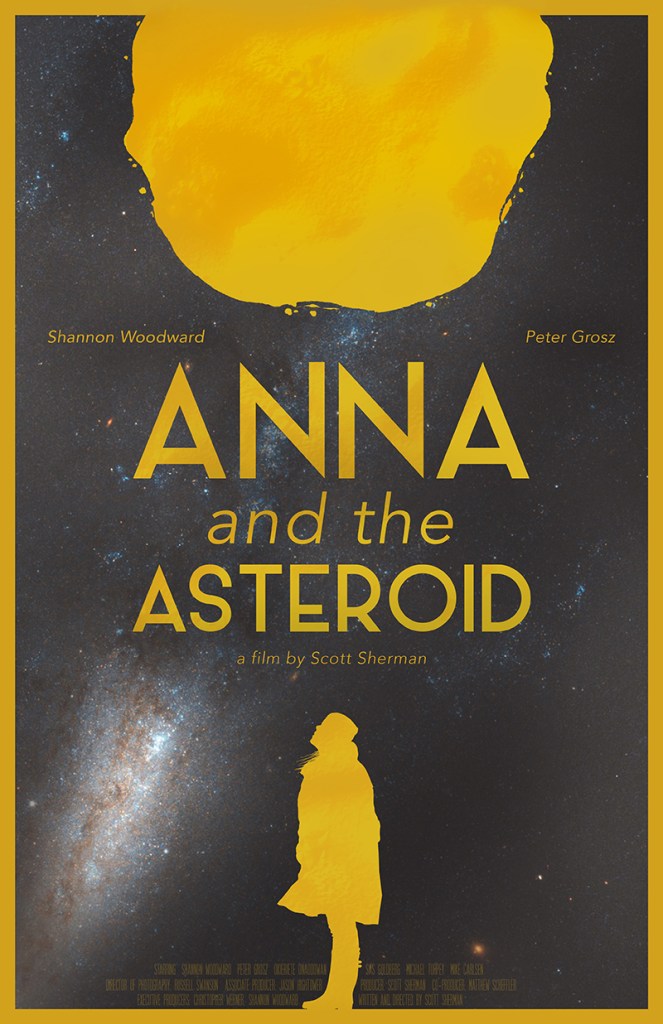 The film poster showing the silhouette of a woman in yellow on a black background. She is looking up at a big yellow asteroid above her.