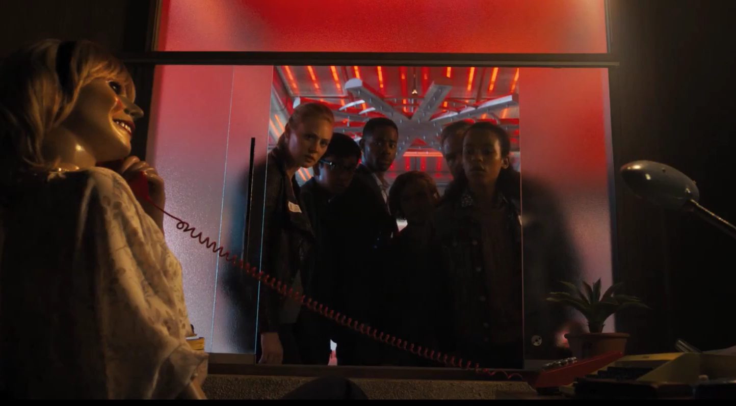 The players looking at a doll that is on the phone. 