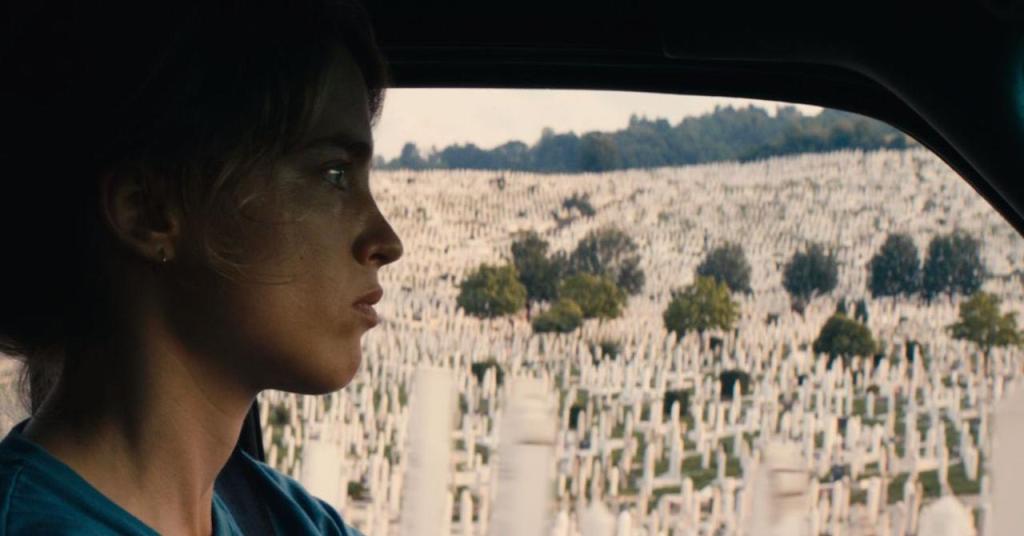 Alice (Adèle Haenel) driving past a huge cemetery filled with white crosses.