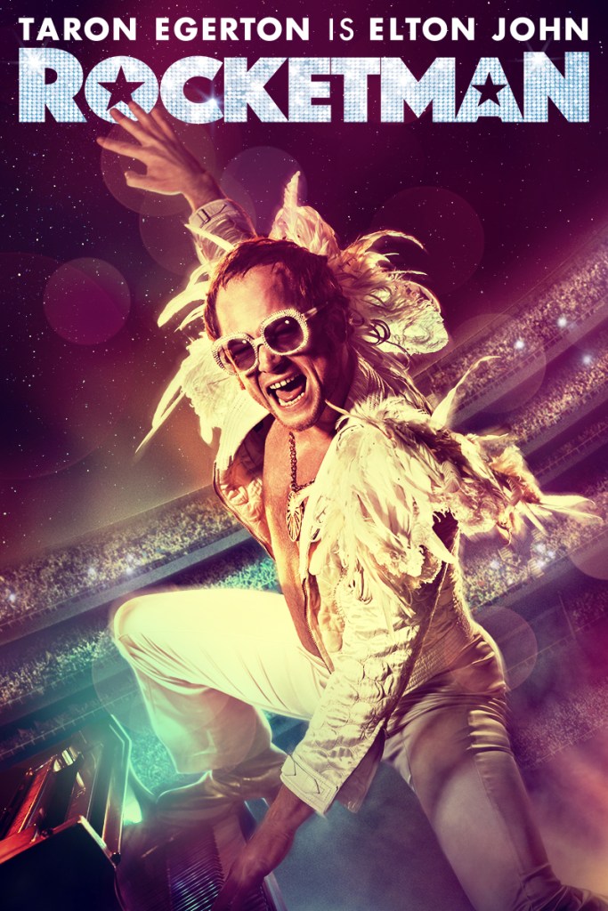 The film poster showing Elton John (Taron Egerton) in a feather costume and huge glasses on stage in a stadium, playing the piano in full rock mode.