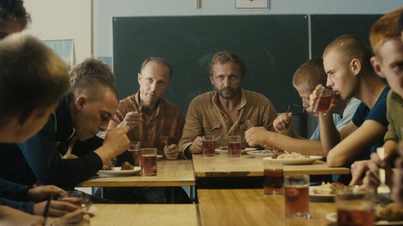 Adam (Andrzej Chyra) and Michal (Lukasz Simlat) having lunch with the boys they supervise.