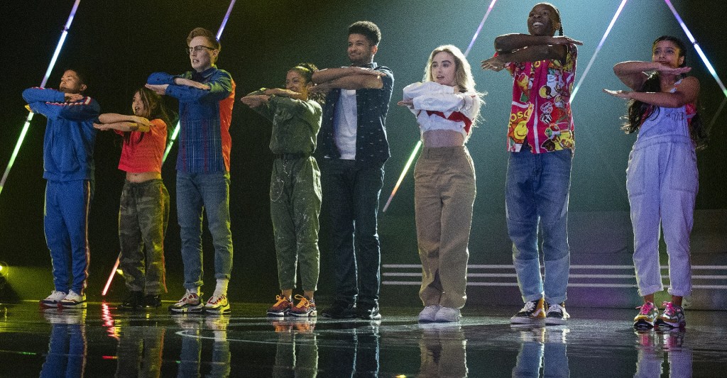 Quinnt (Sabinra Carpenter) and her dance crew, including instructor Jake (Jordan Fisher) during their performance.