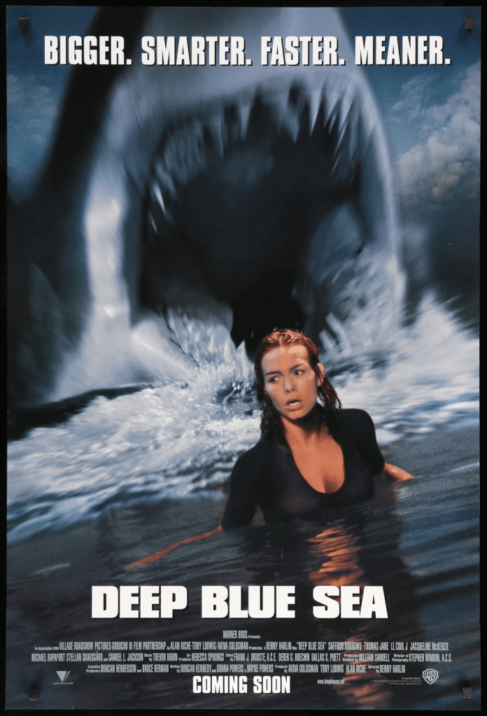 The film poster showing a shark with his mouth open wide behind Susan (Saffron Burrows), up to her breast in water.