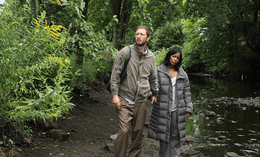 Ethan (Ebon Moss-Bachrach) and Leigh (Aunjanue Ellis) in the forest.
