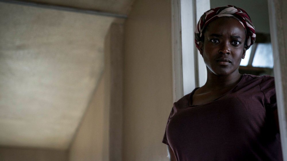 Rial (Wunmi Mosaku) looking worried.