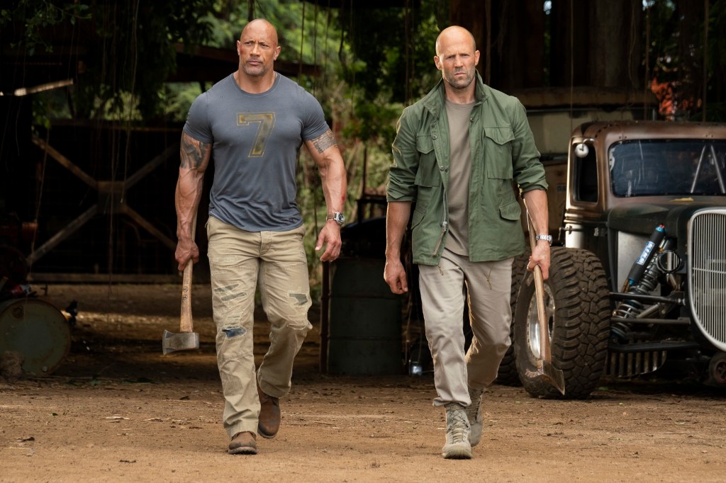 Hobbs (Dwayne Johnson) and Shaw (Jason Statham) walking fiercely, tools in hand.