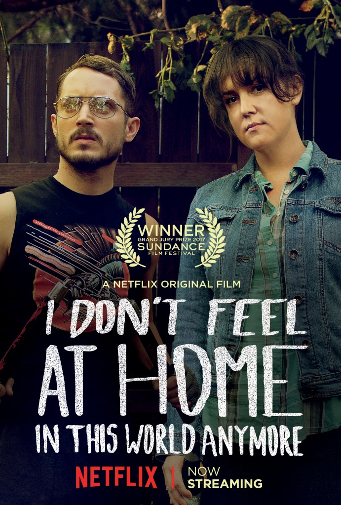 The film poster showing Tony (Elijah Wood) and Ruth (Melanie Linskey) standing with very serious looks in front of a garden fence.