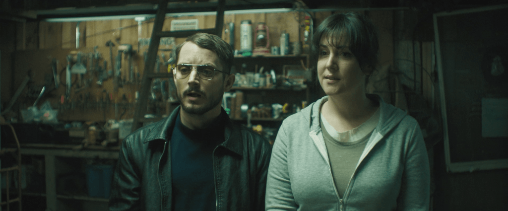 Tony (Elijah Wood) and Ruth (Melanie Linskey) in the second hand shop, looking for Ruth's stuff.