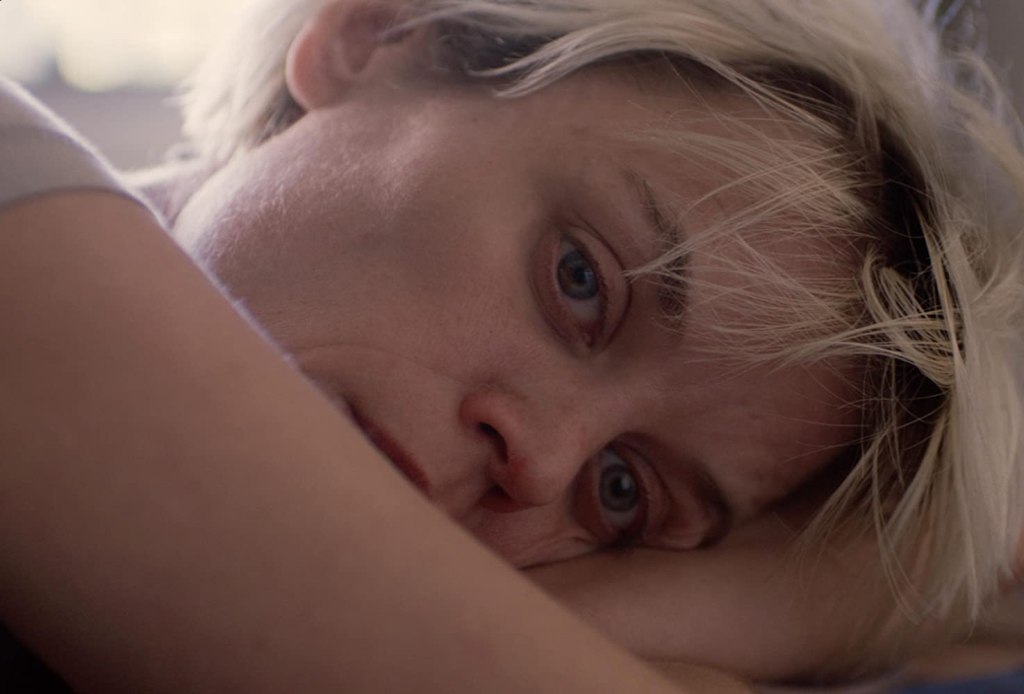 Lexi (Gemma Brockis) resting her head on her arms.