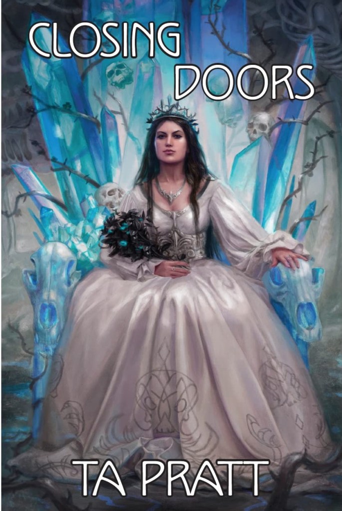 The book cover showing a woman with long black hair in a bridal gown sitting on a thorne of ice, thorns and skulls.