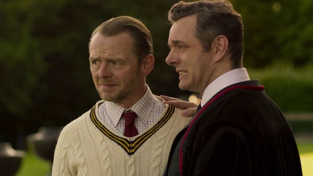 Teacher Meredith (Simon Pegg) and principal The Bat (Michael Sheen) looking at something with a pained expression on their faces.