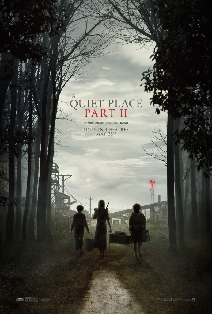 The film poster showing Evelyn (Emily Blunt), Regan (Millicent Simmonds) and Marcus (Noah Jupe) carrying a box and some bags, entering an abandoned factory area from the forest.