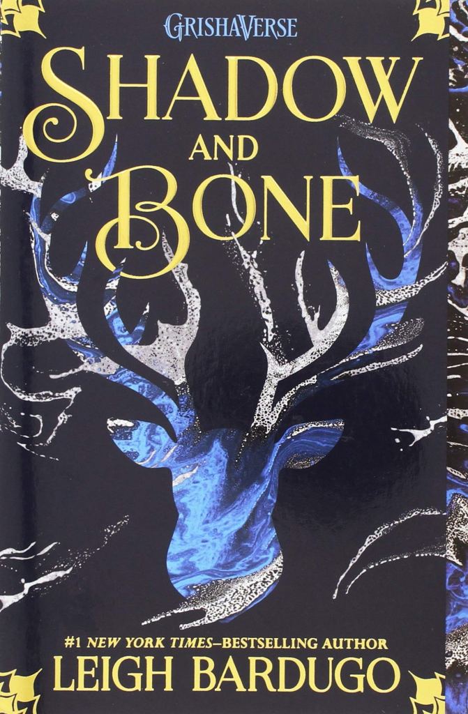 The book cover showing a stag shape that seems to be filled with water or blue color on black background. 