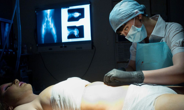 Mary (Katharine Isabelle) finishing an operation. 