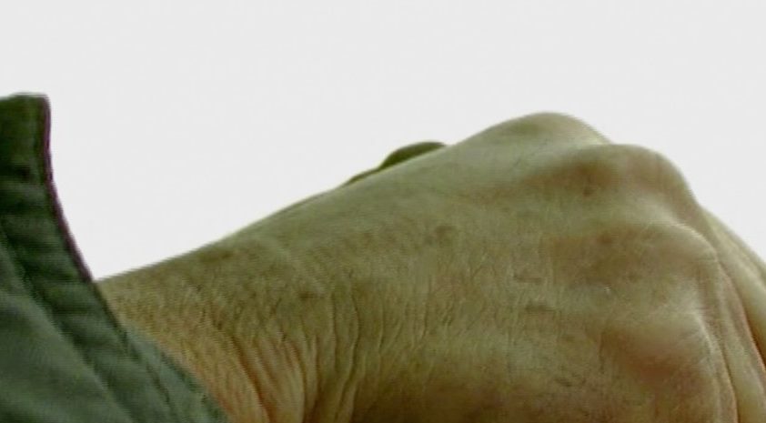 Hands on a steering wheel.