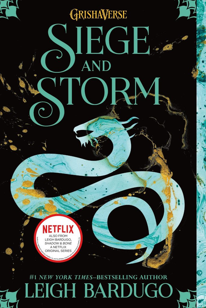The book cover showing a snakelike dragon in shades of turquoise on black background. Golden drops cover the page.