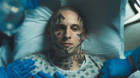 Bryon (Jamie Bell) lying in a hospital bed.