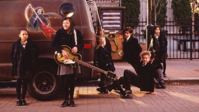 The kids from the band hanging around Dewey's van.