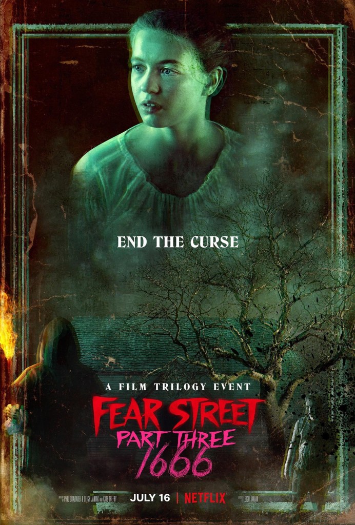 The film poster showing Hannah/Sam (Olivia Scott Welch) tinted in green above a tree, a hooded figure carrying a torch and Solomon Goode (Ashley Zukerman).