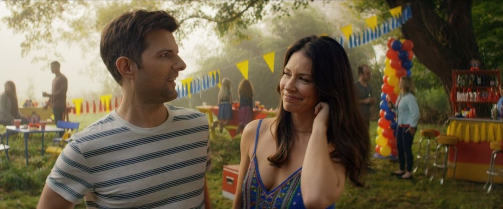 Gary (Adam Scott) and Samantha (Evangeline Lilly) at a children's birthday party, smiling at each other. 