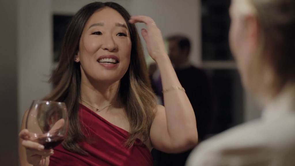Vanessa (Sandra Oh) smiling with a drink in hand.