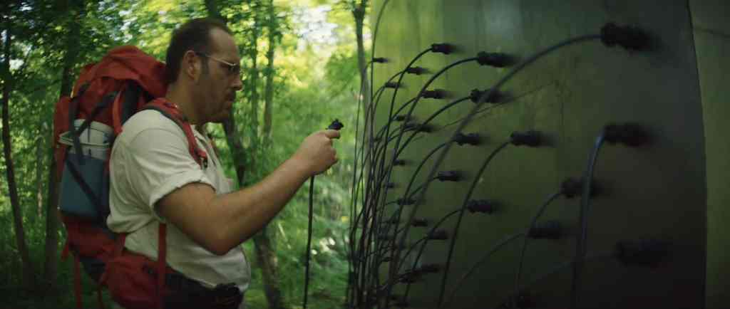 Ray (Dean Imperial) attaching a cable to a cube.