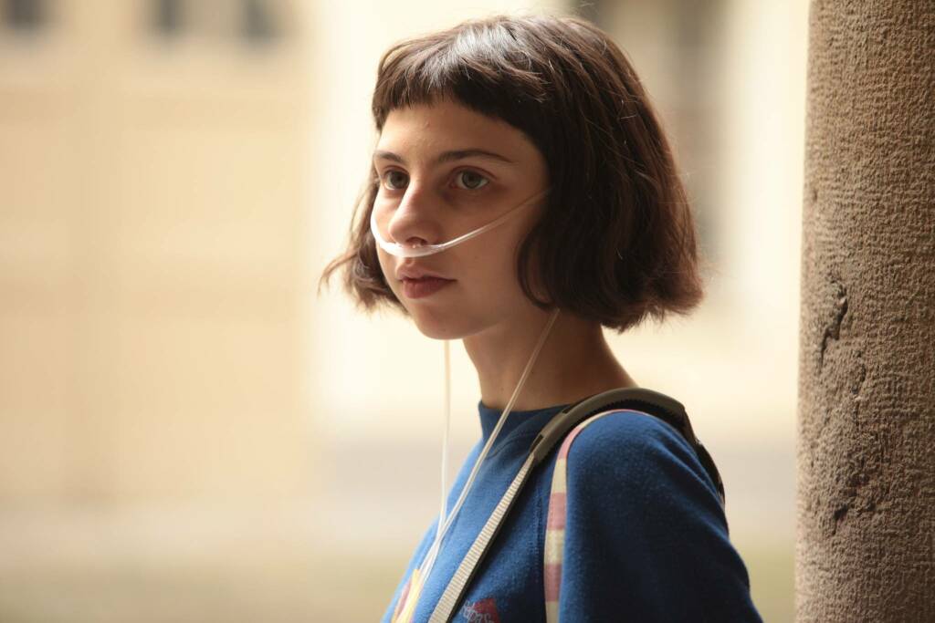 Marta (Ludovica Francesconi) with a breathing tube in her nose.