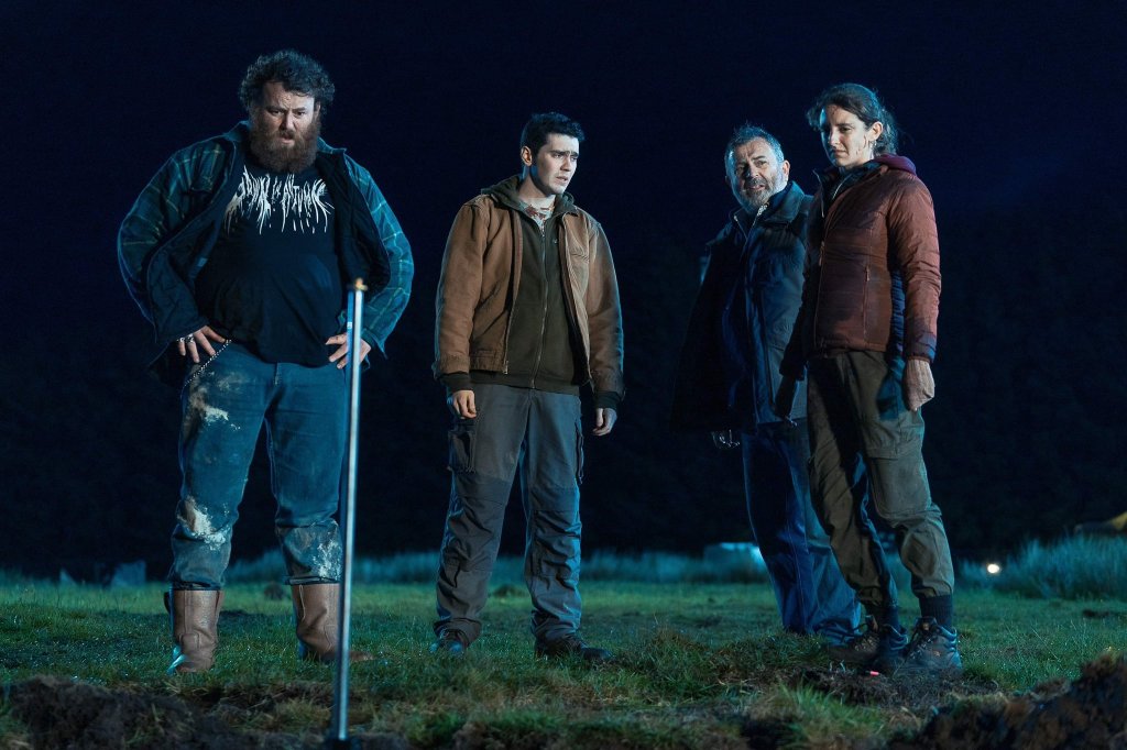 McCauley (Michael Hough), Eugene (Jack Rowan), Francie (Nigel O'Neill) and Claire (Louisa Harland) standing in front of a hole in the ground.