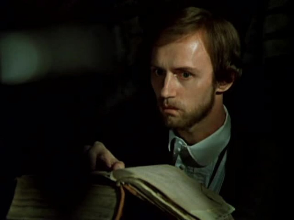 Beloretskiy (Boris Plotnikov) looking at an old book. 