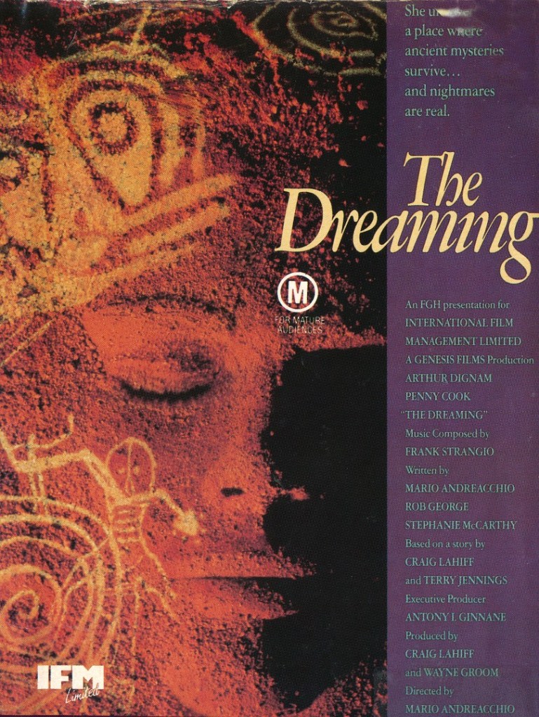 The film poster showing a face made of sand with tribal paintings over it.