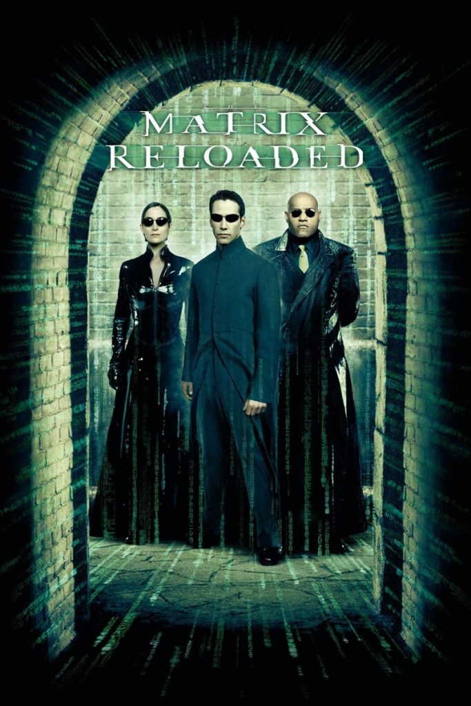 The film poster shwoing Neo (Keanu Reeves) and behind him Trinity (Carrie-Anne Moss) and Morpheus (Laurence Fishburne) in a brick-built tunnel opening.