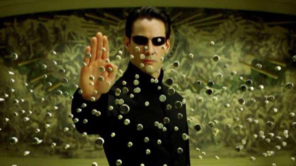 Neo (Keanu Reeves) stopping bullets with a gesture.