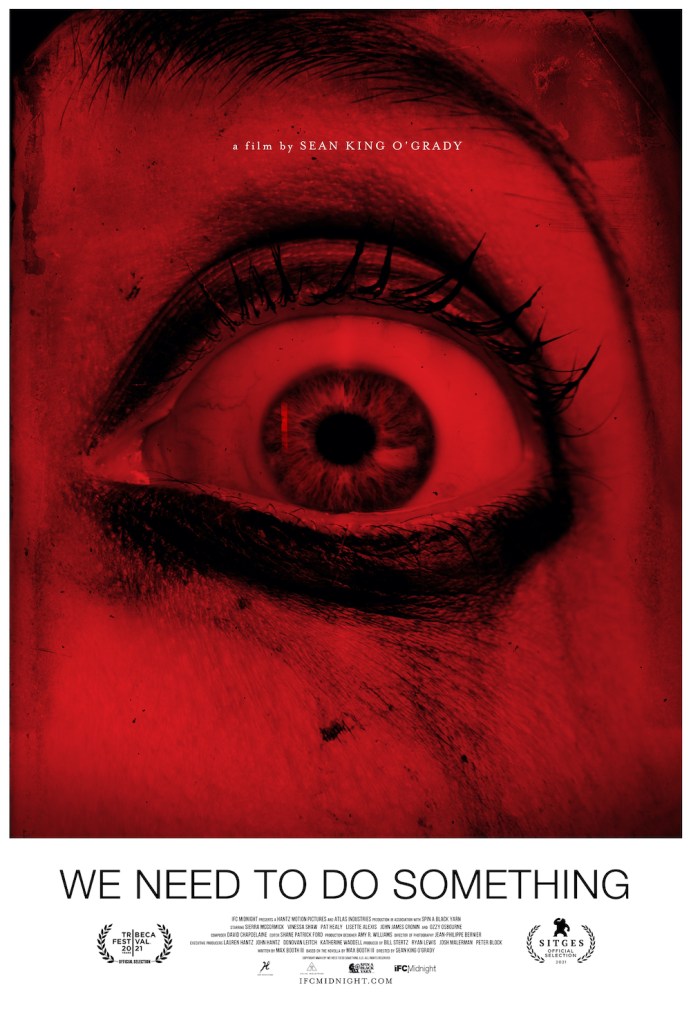 The film poster showing an eye with smudged make-up opened very wide. The image is bathed in red light.