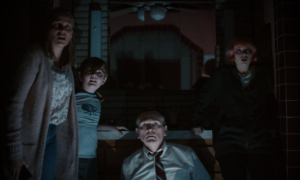 Diane (Vinessa Shaw), Bobby (John James Cronin), Robert (Pat Healy) and Melissa (Sierra McCormick) huddled in the dark bathroom.