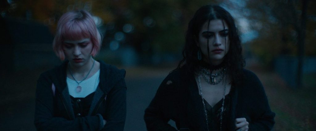 Melissa (Sierra McCormick) and Amy (Lisette Alexis) walking together.