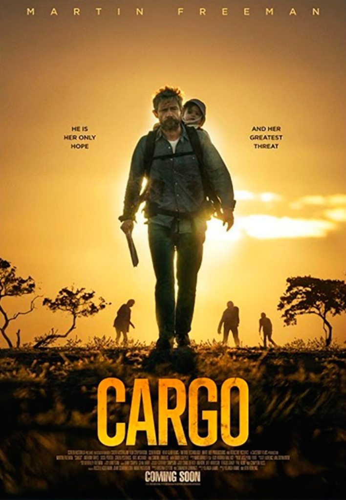 The film poster showing Andy (Martin Freeman) walking through the outback with a baby on his back. He is holding a machete and behind him are three zombies in the distance.