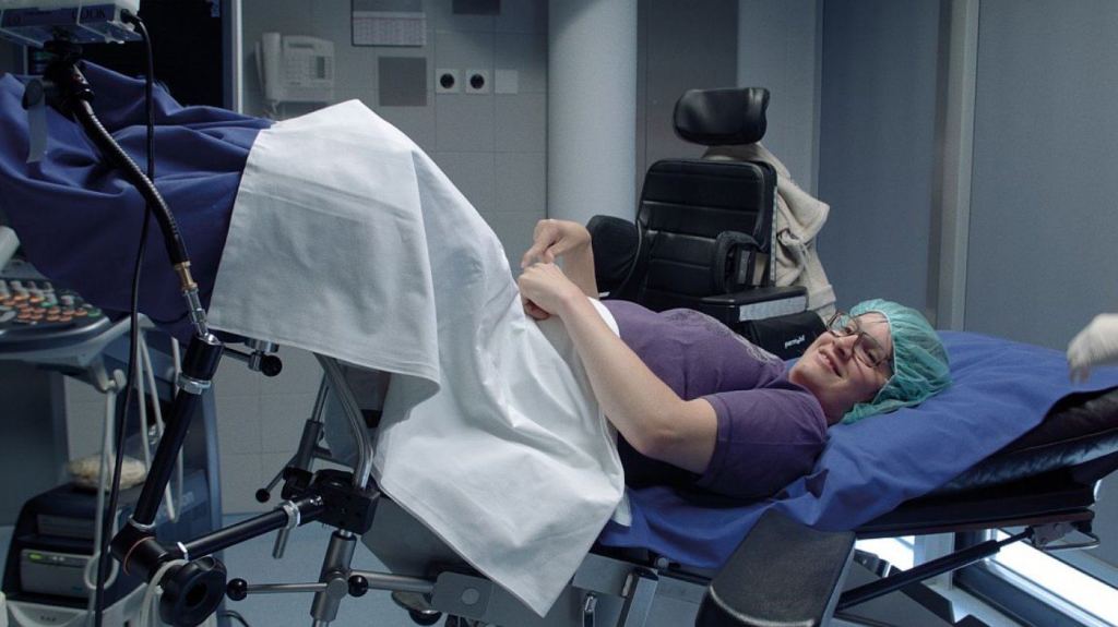 Eva-Maria lying in a treatment chair at the fertility clinic.