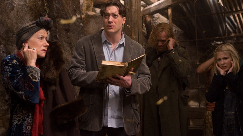 Mo (Brendan Fraser) reading from a book as Elinor (Helen Mirren), Dustfinger (Paul Bettany) and Meggie (Eliza Bennett) cover their ears.