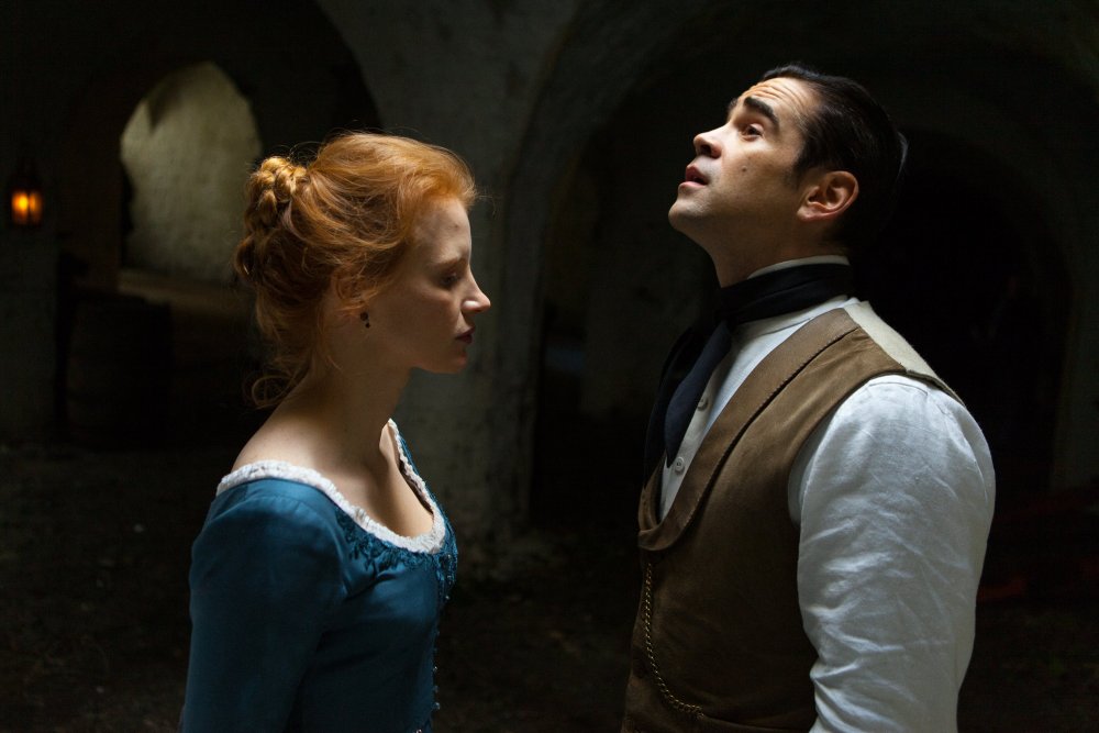 Miss Julie (Jessica Chastain) and Jean (Colin Farrell) standing close to each other in a cellar.