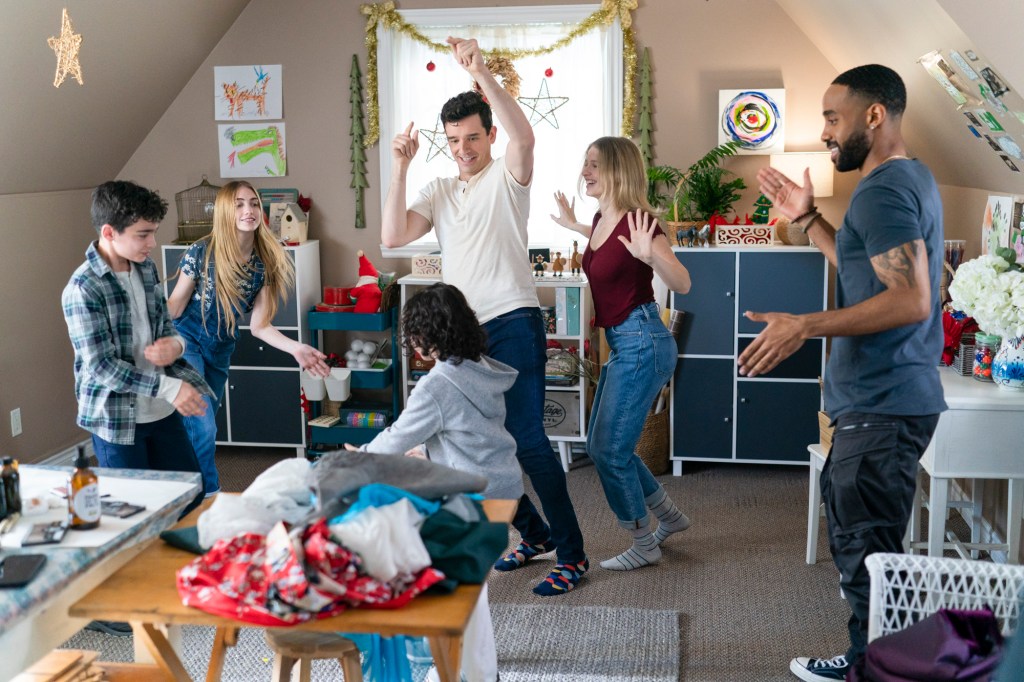 Peter (Michael Urie) and Nick (Philemon Chambers) dancing around with the children of Peter's family.