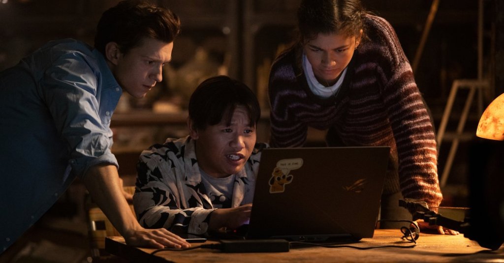 Peter (Tom Holland), Ned (Jacob Batalon) and MJ (Zendaya) leaning over a laptop.