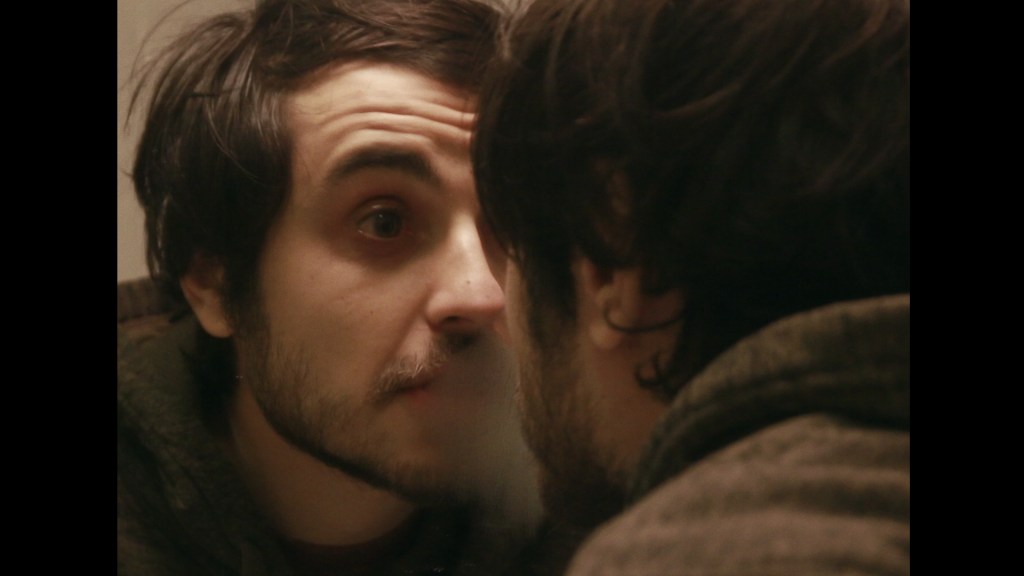 Adrian looking at himself in the mirror.