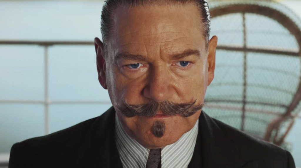 Hercule Poirot (Kenneth Branagh) sporting an elaborate moustache, looking very serious indeed.