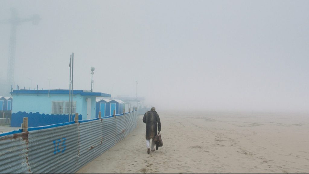 Richie Bravo (Michael Thomas) walking along the beach in the fog.