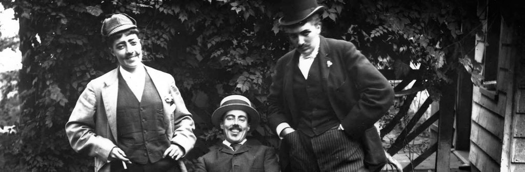A photograph by Alice Austen showing her and two female friends dressed as men.