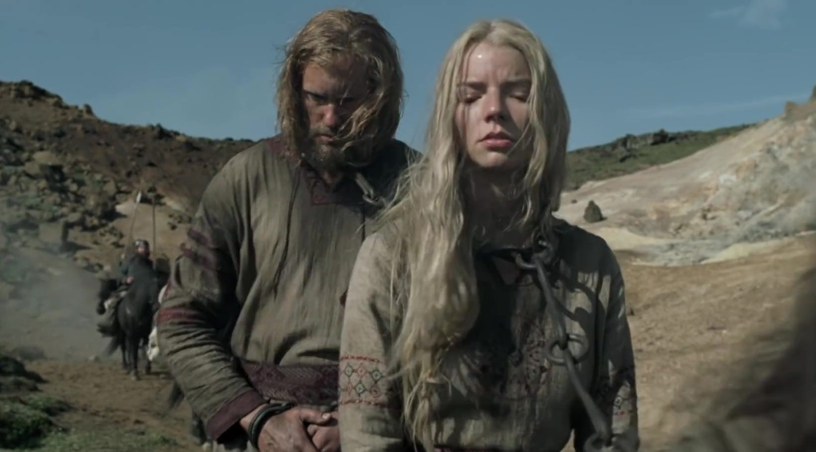 Amleth (Alexander Skarsgård) and Olga (Anya Taylor-Joy) walking in a line of prisoners and slaves.