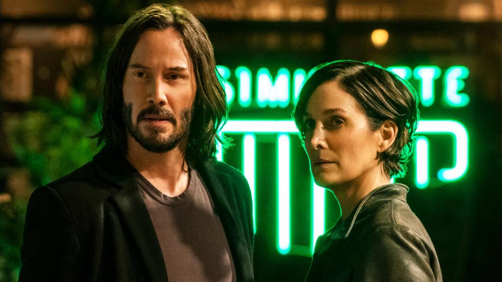 Neo (Keanu Reeves) and Trinity (Carrie-Anne Moss) standing in a coffee shop.